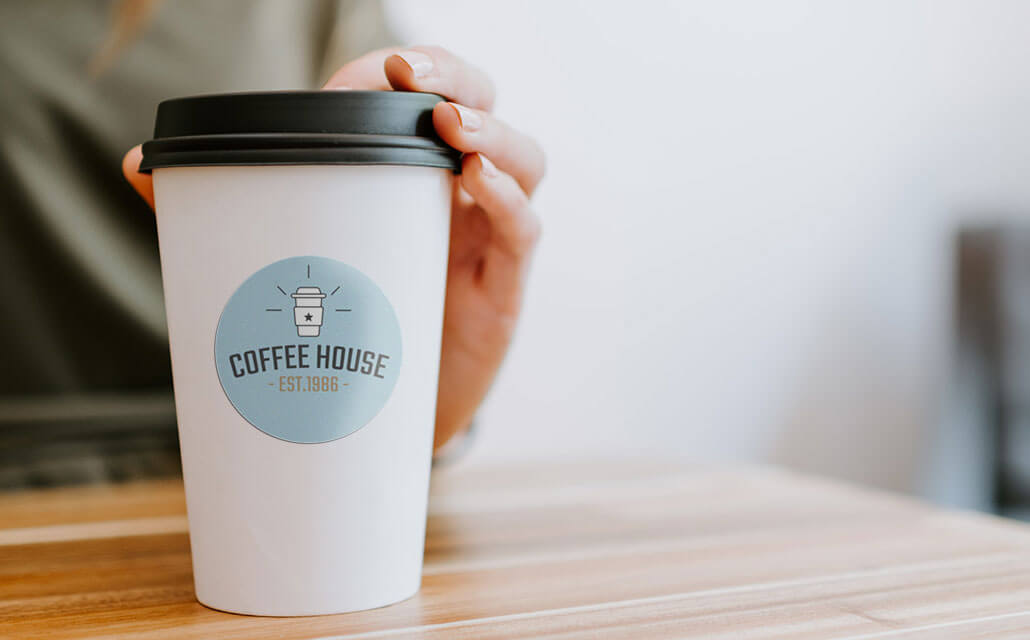 Coffee house logo sticker on a cup.