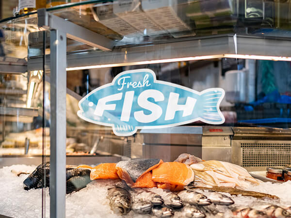 Front adhesive sticker of a fish in a fish shop window.
